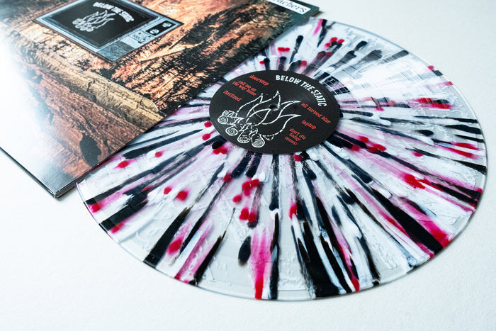A clear Presale Vinyl LP with black and red splatter partially slides from its album cover, which depicts mountains. The center label displays The Bar Stool Preachers branding and Below The Static Vinyl album info.