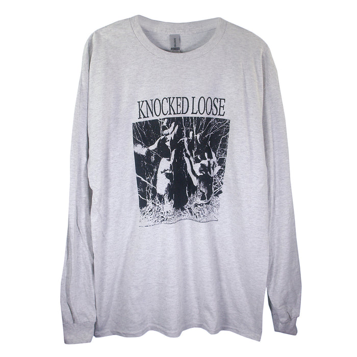 A light gray Knocked Loose long-sleeve shirt featuring a black-and-white front graphic with the band’s name above an abstract image of trees and branches.
