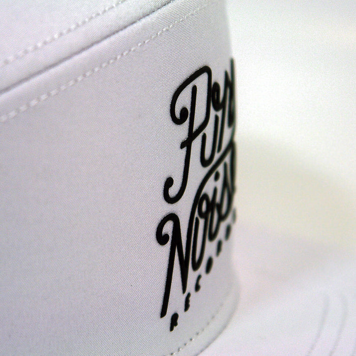 Close-up of a white hat from Pure Noise Records Merch, featuring Pure Noise Records printed in black script on the front.