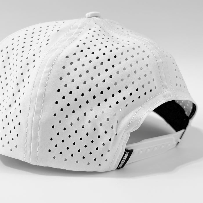 A black-and-white close-up of the back of a Pure Noise Records Merch white baseball cap, featuring small ventilation holes, an adjustable strap, and a side tag.