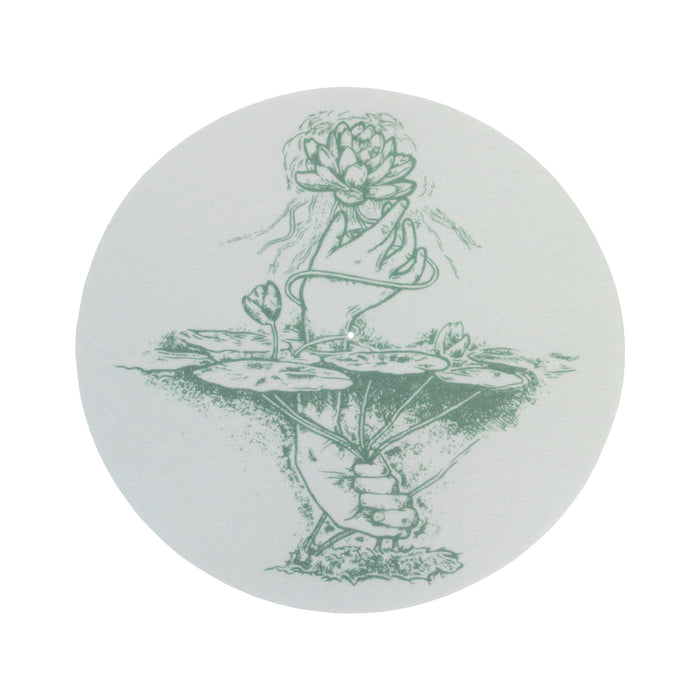 A circular line drawing by Moon Tooth: one hand raises a lotus flower above water while another grasps lotus stems below. Its soft, botanical style is ideal for a white slipmat and takes inspiration from phototroph beauty.
