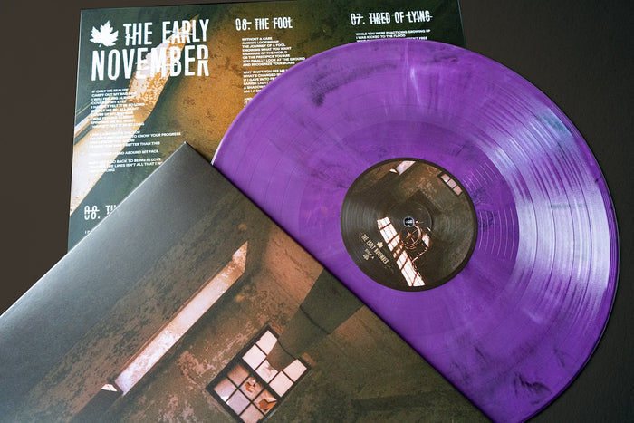 A purple The Early November Eco Mix Vinyl peeks from its album cover, with an insert listing songs and lyrics. The moody cover art completes this stunning LP—get The Early Novembers Eco Mix Vinyl on presale now.
