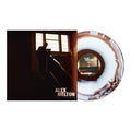 ALEX MELTON’s "THE PROCESS" album vinyl, with a white and brown marbled pattern, is shown beside its cover—a silhouette on stairs by a window. Available now for presale.