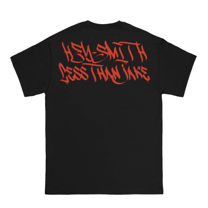 A black Less Than Jake Heavy T-shirt with "KELLY SMITH" and "LESS THAN JAKE" in bold red graffiti lettering on the back—perfect for fans of unique prints.